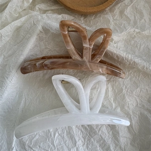 Elegant large butterfly hair claws in amber brown and marble cream finish with hollow design