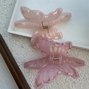 Detailed macro view of high-quality resin butterfly hair clips with ribbon edge details
