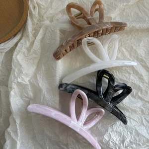 Detailed set of four hollow butterfly hair claws in marble and ink patterns