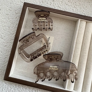 Three-piece set of amber acetate hair claws with gold Barrette La France branding