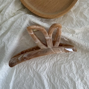Close-up of a large marbled ink butterfly hair claw clip with a durable resin finish