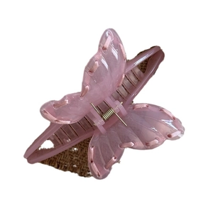 Pink ribbon butterfly hair claw clip with translucent finish and woven ribbon details