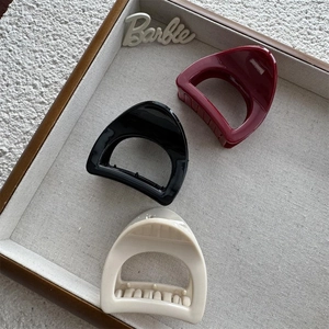 Three-piece set of glossy cutout hair claws in black, burgundy, and cream beige