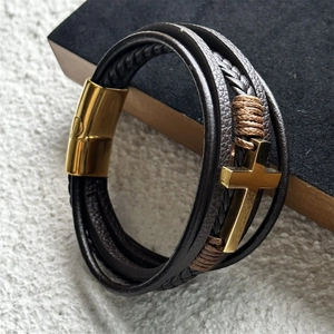 Detailed view of multilayer leather bracelet with cross charm and magnetic metal clasp