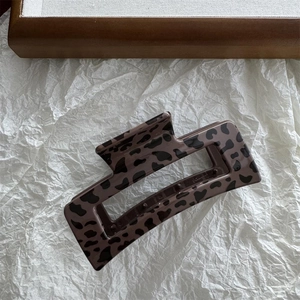 Detail of large leopard print rectangular claw clip with polished acetate finish