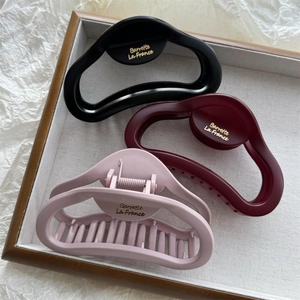 Detailed view of matte large cloud hair claws in black, burgundy and light pink colors