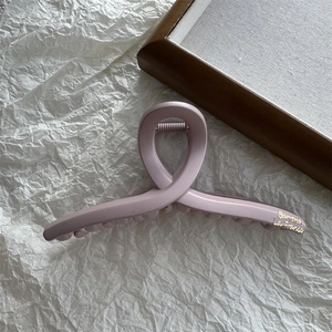 Close-up of matte pink large cloud hair claw with golden Barrette La France lettering