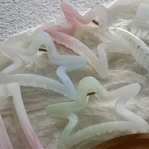 Pinces à cheveux étoiles de mer aux couleurs pastel avec paillettes sur papier froissé