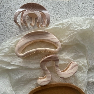 Vue détaillée de grandes pinces à cheveux marbrées pour une coiffure élégante