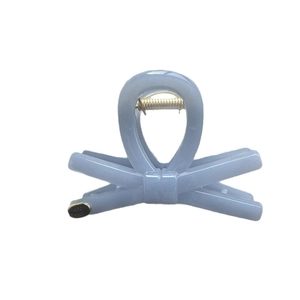 Minimalist light blue resin hair claw clip with knot design and gold spring detail