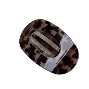 Elegant tortoiseshell pattern acetate hair claw clip with minimalist oval hollow design