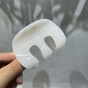 Close-up of a cream white French style hair claw clip made of smooth acrylic material