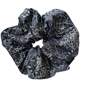 Navy blue fabric hair scrunchie with white paisley pattern and pleated texture