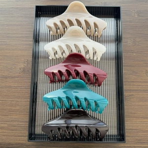 Detailed top view of 5 large resin shark hair clips in assorted glossy fashion colors