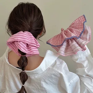 Pink striped and plaid oversized scrunchie set with blue ruffled edges for hair styling