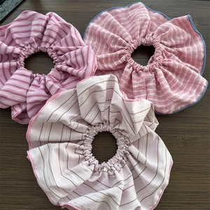 Close-up of pink and purple striped scrunchies set with detailed contrast edge stitching