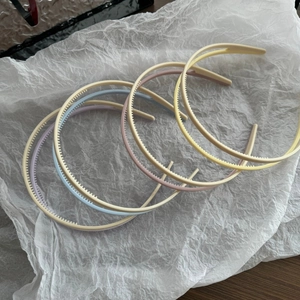 Detail of candy-colored plastic headbands with non-slip teeth for secure daily hair styling