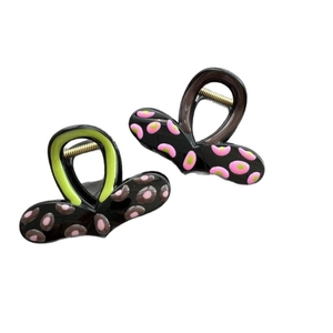 Set of two colorful polka dot shark hair clips in black with pink green and coffee accents