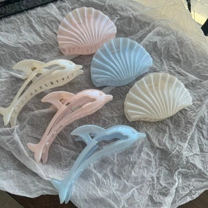 Elegant pearlescent dolphin and shell hair claws in pink, blue, and white colors