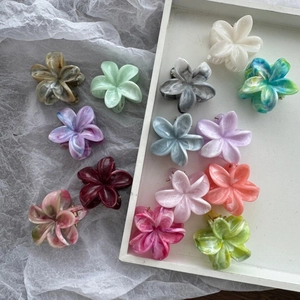 Floral marble pattern hair clips in multiple pastel colors arranged on a white tray