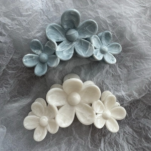 Elegant marble pattern camellia hair clips in grey-blue and cream white marble finish