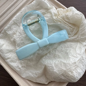 Detailed macro view of the light blue marble texture on the acetate hair claw clip