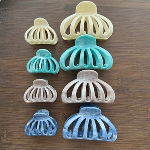 Macro detail of marble pattern hair claw clips in various sizes and elegant colors