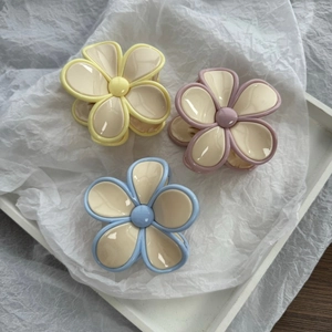 Three elegant pastel flower hair claws in yellow, purple and blue for women