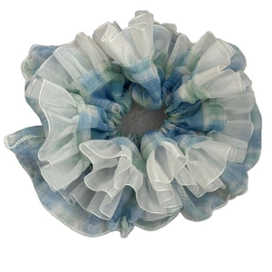 Lolita light blue plaid scrunchie with white organza ruffled edges on a clean background