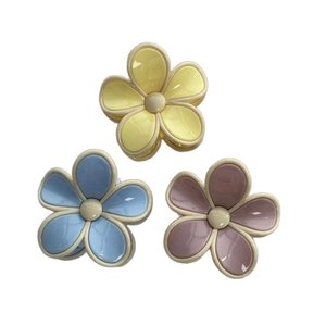 Three elegant pastel flower hair claws in yellow, blue and pink with creamy white borders