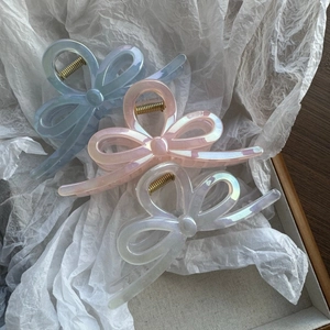 Three-piece large mermaid bow hair claws in pearlescent blue, pink, and white colors