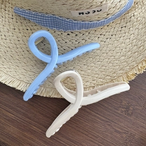 Light blue and cream white oversized twisted hair claw clips for women hair styling