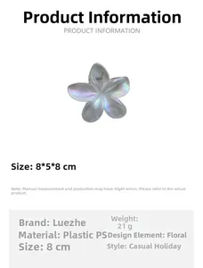 Detail view of the iridescent plumeria hair claw clip with its specific dimensions and weight