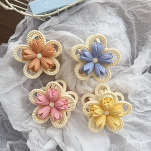 Set of four matte tulip flower hair claws in pastel pink, blue, yellow, and orange tones