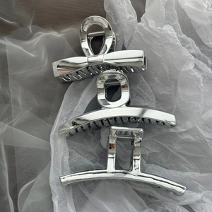 Three-piece set of silver metallic acrylic hair claws in bow, arc, and square designs