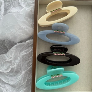 Set of four large cherry saturn hair claws in beige, blue, brown and mint green colors