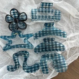 Detailed set of diverse blue gingham pattern hair claw clips in various geometric shapes