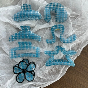 Blue checkered hair claw set with flower and geometric shapes on white paper