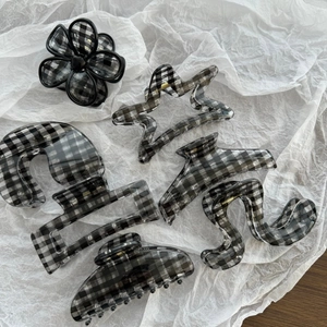 Minimalist black and white checkerboard hair claw clip set in various geometric shapes
