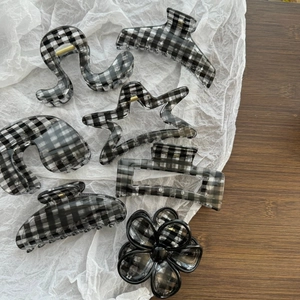 Set of minimalist black and white checkerboard claw clips in various geometric shapes