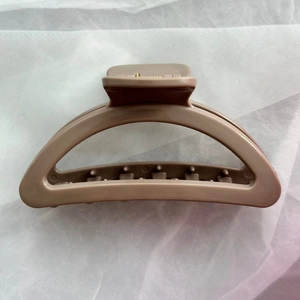 Detail view of khaki matte silicone hair claw clip showing inner spring and teeth