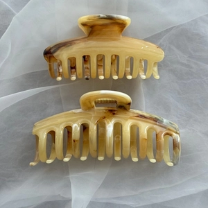 Amber marble acetate hair claw clip set with golden spring on white organza