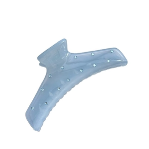 Glossy light blue hair claw clip with rhinestones shown on a clean white background