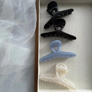 Set of four glossy French style hair claws in cream, blue, coffee and black colors