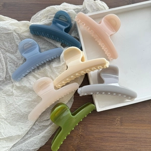 Matte pastel butterfly hair claws in seven soft colors on elegant background display