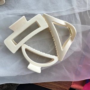 Detailed close-up of cream silicone hair claw set with rectangular and geometric shapes