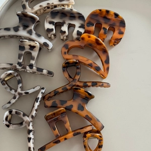 Close-up of leopard and tortoiseshell patterns on various hair claws with metal springs