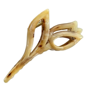 Elegant tulip-shaped hair claw with cream marble texture and golden metal spring