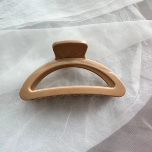 Close-up of soft khaki silicone hair claw clip with interlocking teeth for hairstyling