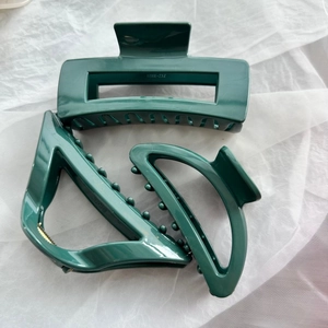 Three-piece dark green soft silicone hair clips in geometric shapes for secure grip